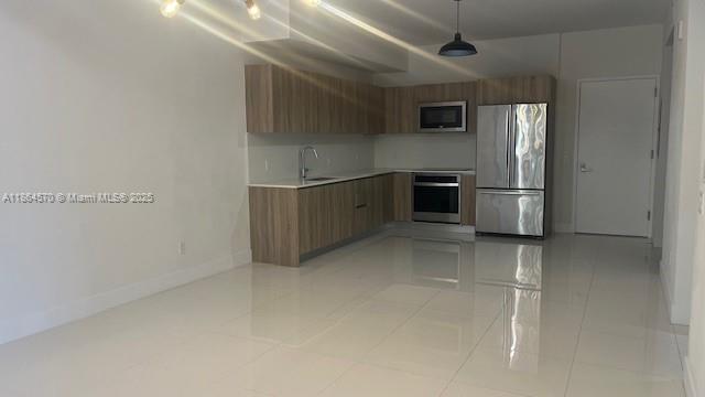2960 Northeast 207th Street, Unit 607 Aventura, FL 33180 - Photo 2 of 11 a kitchen with stainless steel appliances a refrigerator and a stove top oven