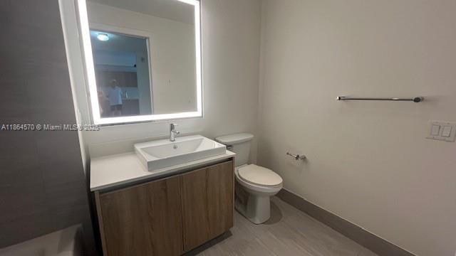 2960 Northeast 207th Street, Unit 607 Aventura, FL 33180 - Photo 8 of 11 a bathroom with a sink toilet and mirror