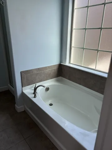 a bath tub sitting next to a window