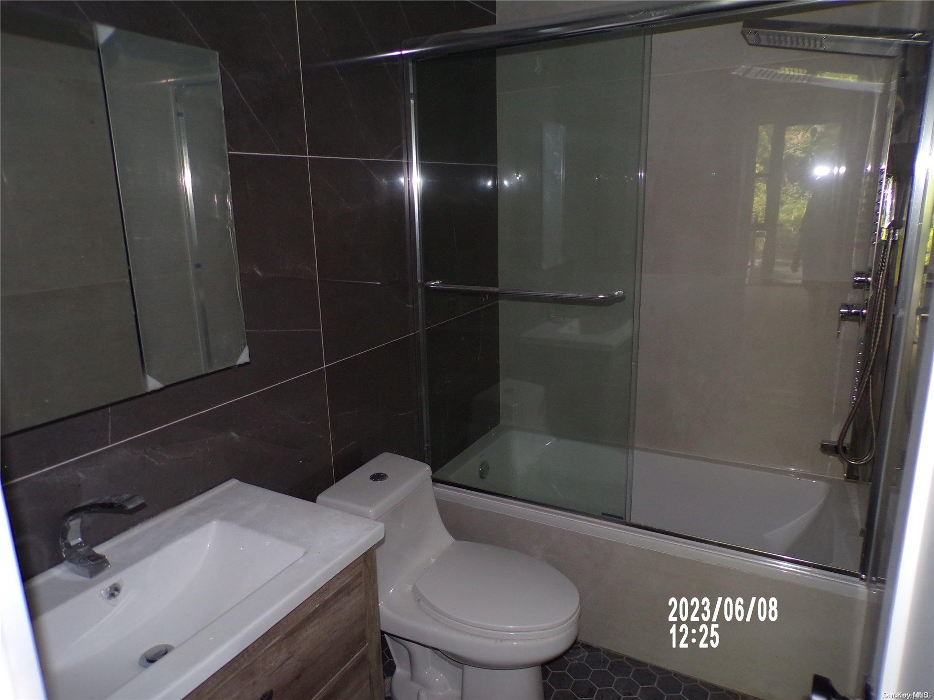 695 Monroe Street Brooklyn, NY 11221 - Photo 20 of 23 a bathroom with a sink a toilet and shower