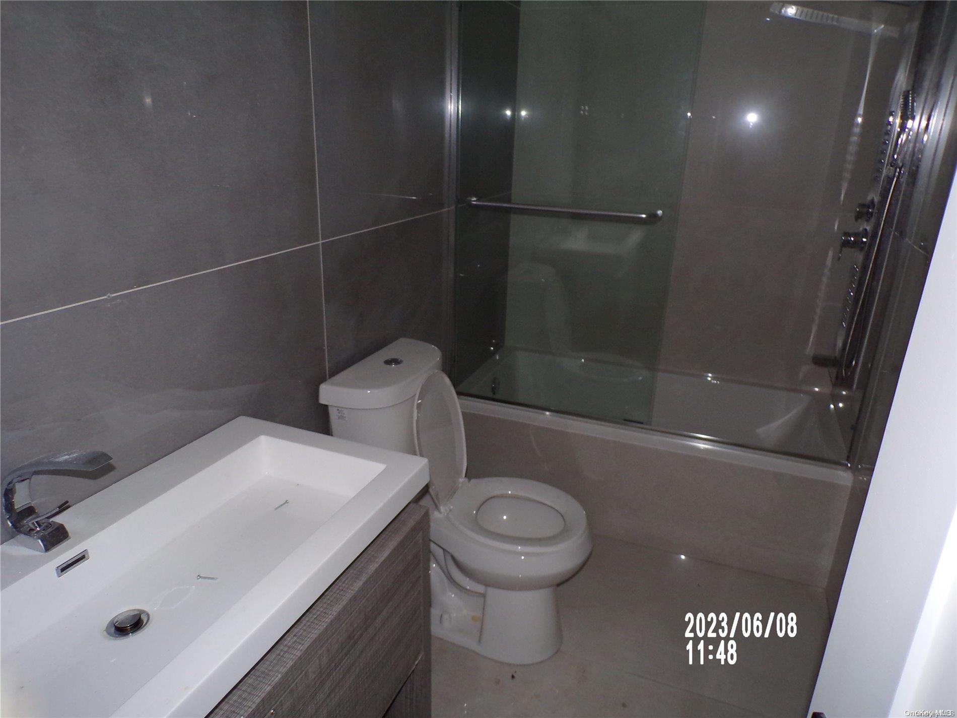 695 Monroe Street Brooklyn, NY 11221 - Photo 4 of 23 a bathroom with a sink a toilet and shower