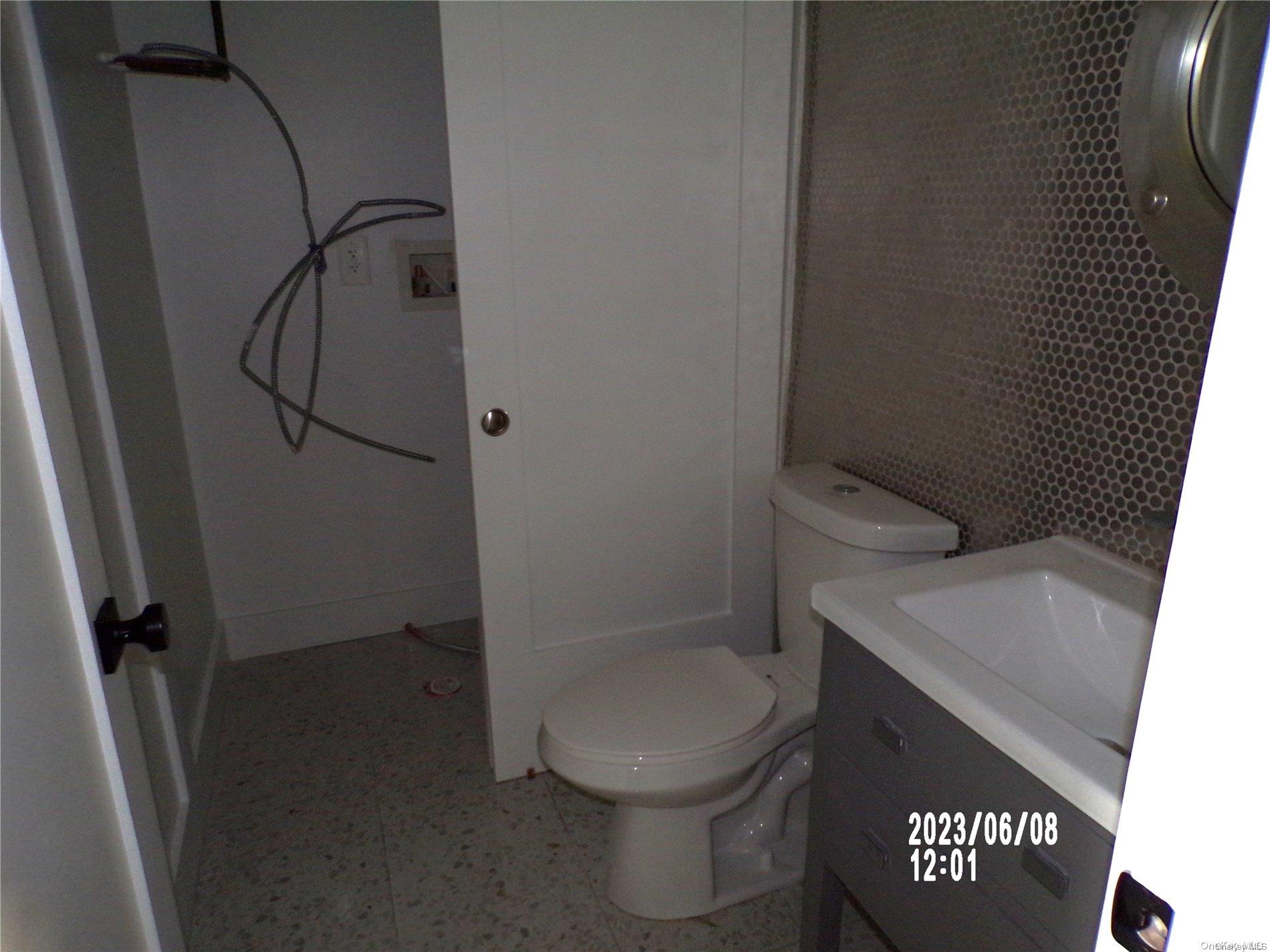 695 Monroe Street Brooklyn, NY 11221 - Photo 6 of 23 a bathroom with a toilet and a shower