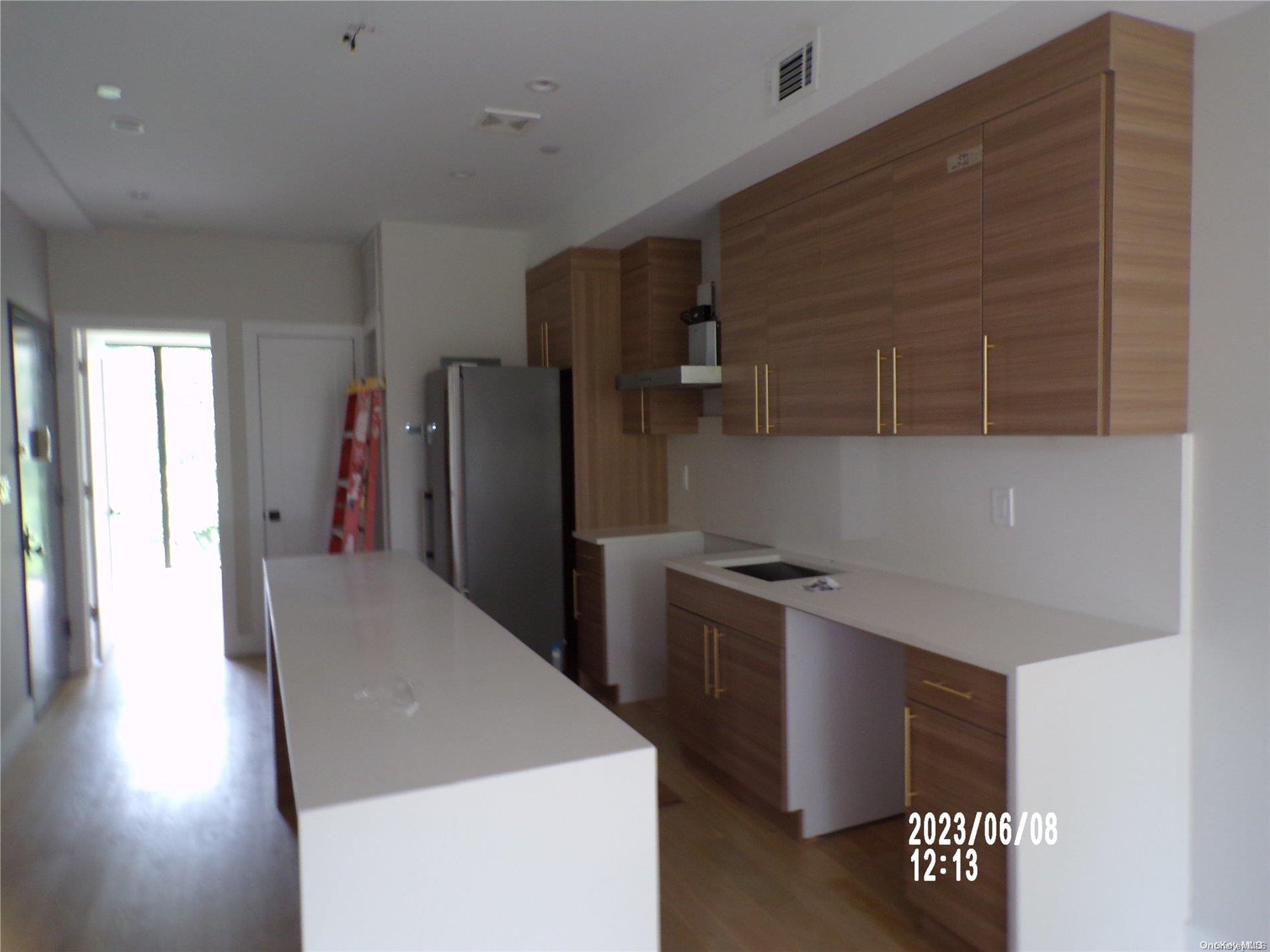 695 Monroe Street Brooklyn, NY 11221 - Photo 9 of 23 a kitchen with stainless steel appliances a refrigerator and a stove