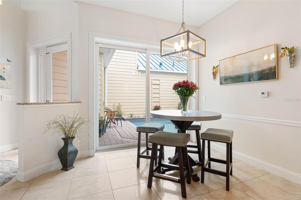 4642 Riverwalk Village Court Ponce Inlet, FL 32127 - Photo 23 of 98 a view of a dining room with furniture and chandelier
