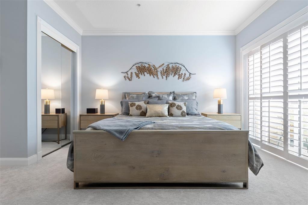 4642 Riverwalk Village Court Ponce Inlet, FL 32127 - Photo 28 of 98 a bed sitting in a spacious bedroom next to a window