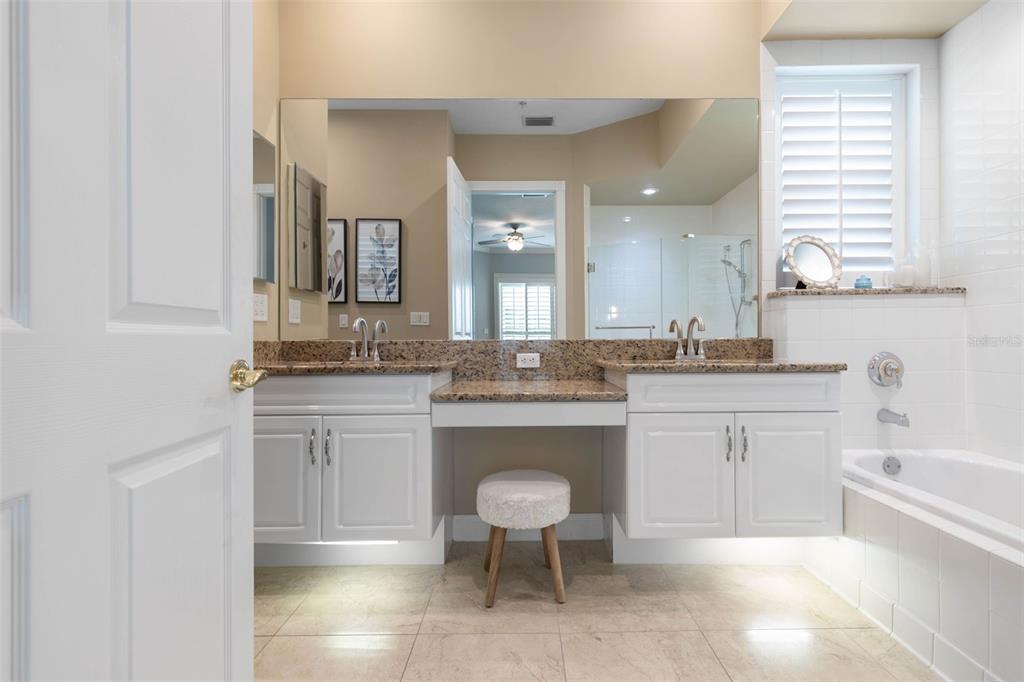 4642 Riverwalk Village Court Ponce Inlet, FL 32127 - Photo 31 of 98 a spacious bathroom with a granite countertop sink a toilet a mirror and bathtub