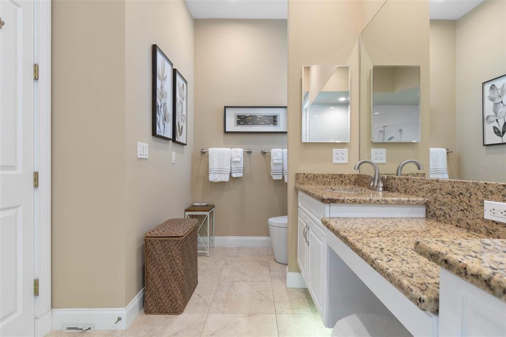4642 Riverwalk Village Court Ponce Inlet, FL 32127 - Photo 33 of 98 a bathroom with a granite countertop sink and a mirror