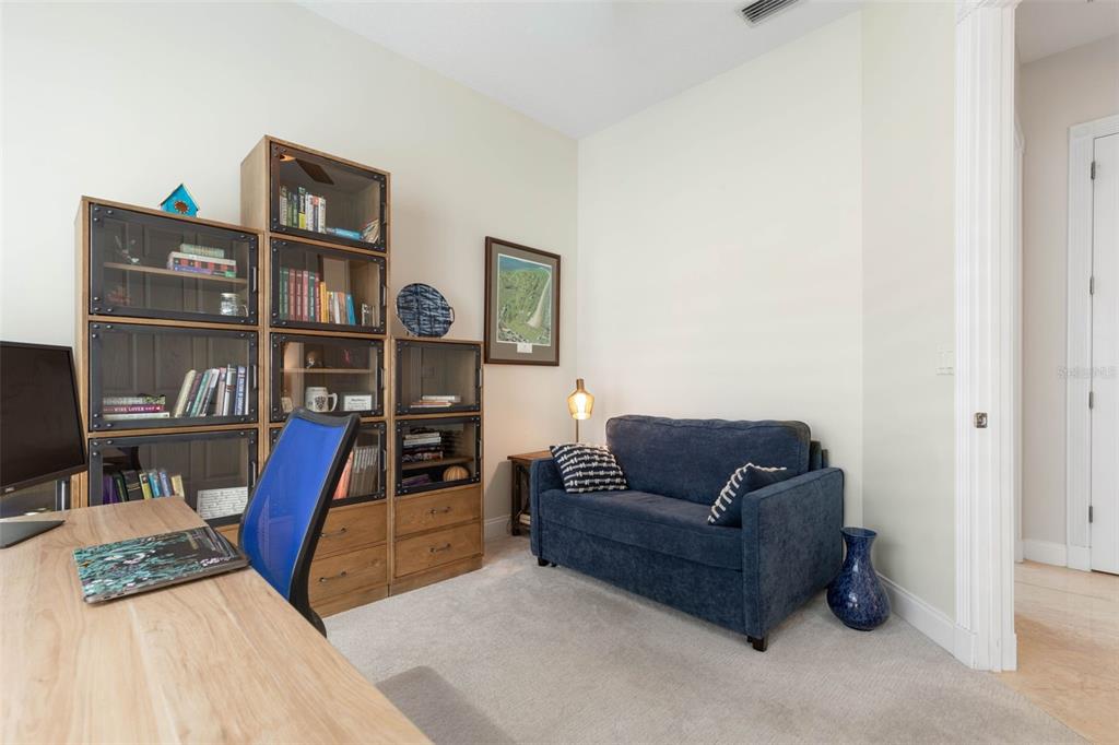 4642 Riverwalk Village Court Ponce Inlet, FL 32127 - Photo 37 of 98 a living room with furniture and a book shelf