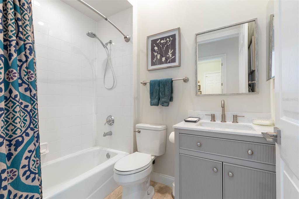 4642 Riverwalk Village Court Ponce Inlet, FL 32127 - Photo 38 of 98 a bathroom with a toilet sink vanity tub and mirror