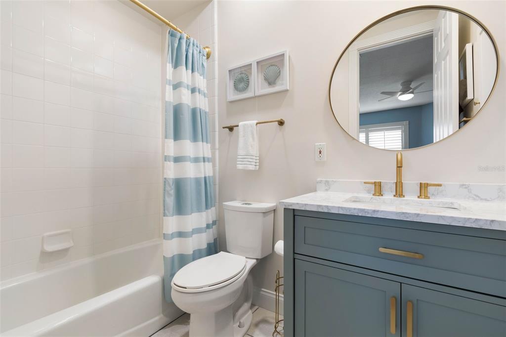 4642 Riverwalk Village Court Ponce Inlet, FL 32127 - Photo 47 of 98 a bathroom with a granite countertop toilet a sink and a mirror