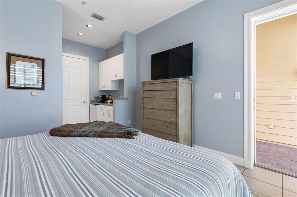 4642 Riverwalk Village Court Ponce Inlet, FL 32127 - Photo 51 of 98 a bedroom with a bed and a flat screen tv