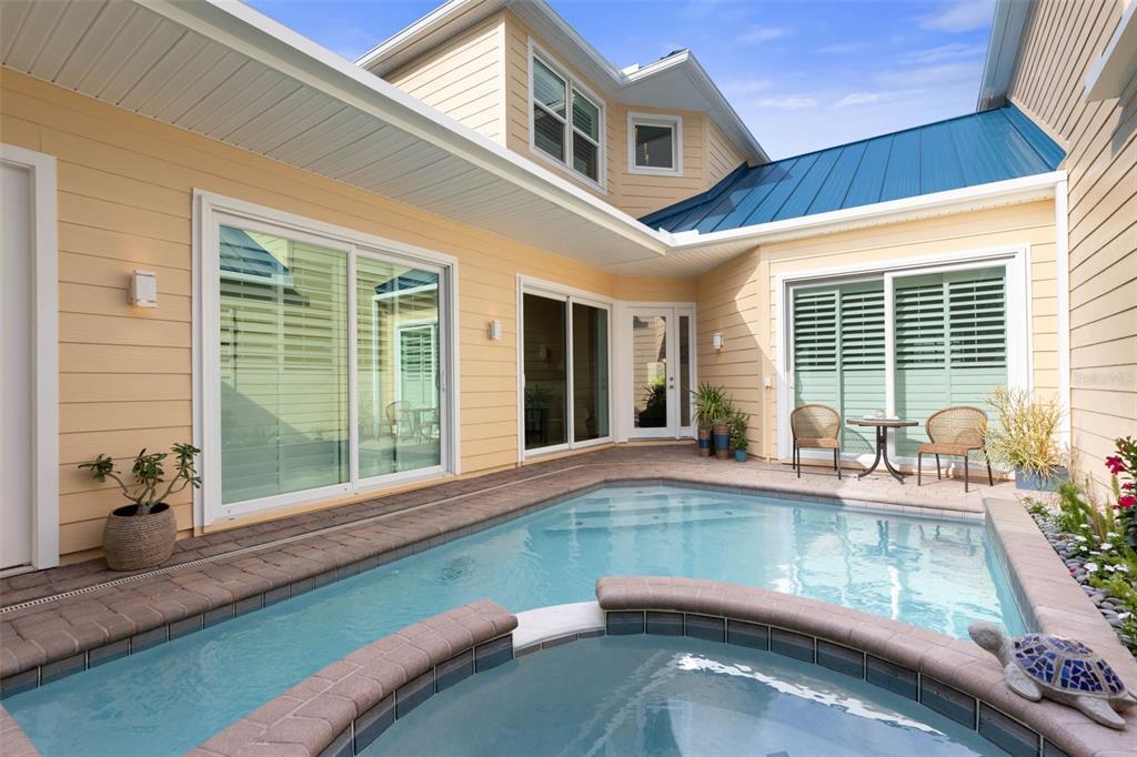 4642 Riverwalk Village Court Ponce Inlet, FL 32127 - Photo 9 of 98 a view of a house with a swimming pool and a porch