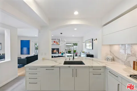 a kitchen with a sink a stove and cabinets