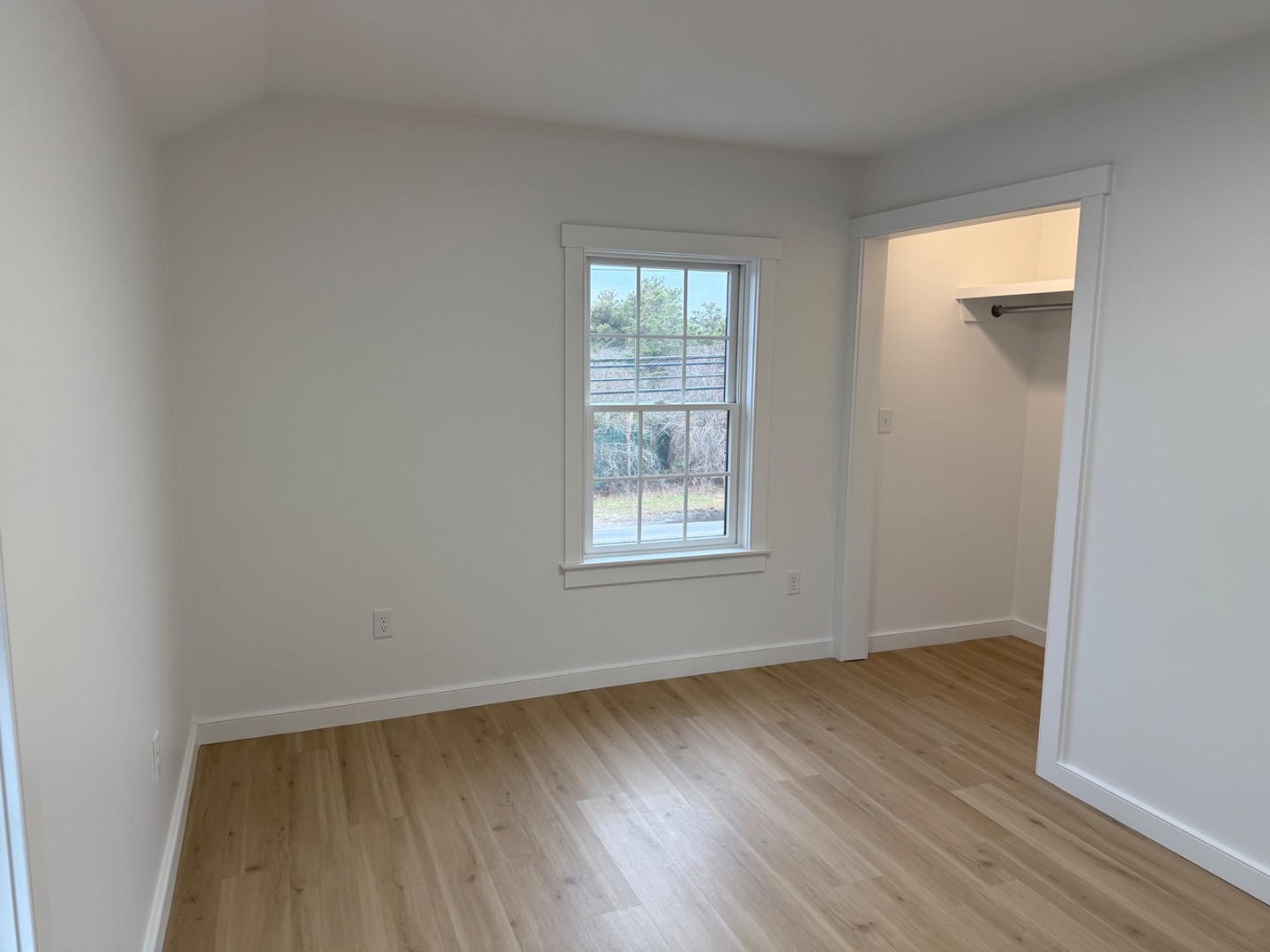 106 Old South Road, Unit A B Nantucket, MA 02554 - Photo 14 of 24 an empty room with wooden floor and windows