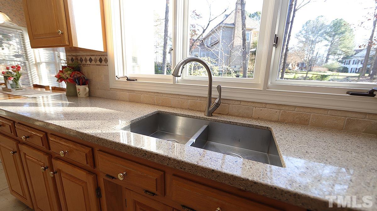 409 Guy Walker Way Durham, NC 27703 - Photo 11 of 47 a kitchen with granite countertop a sink and a window