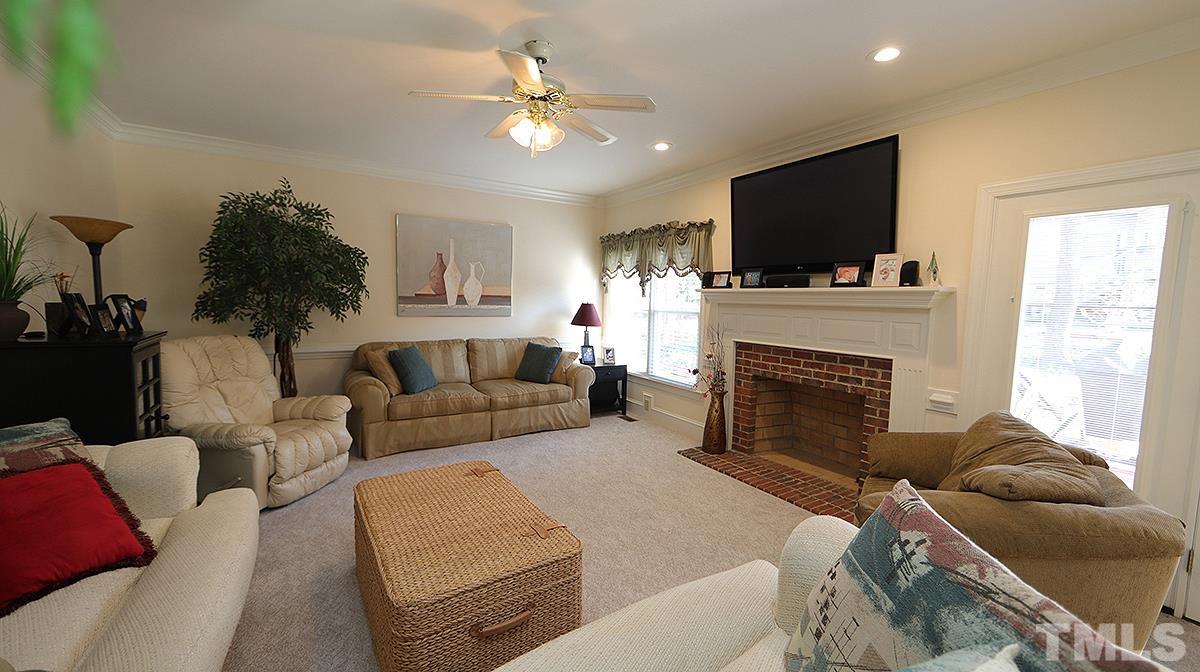 409 Guy Walker Way Durham, NC 27703 - Photo 14 of 47 a living room with furniture a flat screen tv and a fireplace