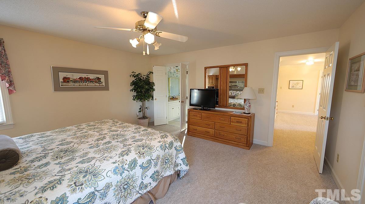 409 Guy Walker Way Durham, NC 27703 - Photo 21 of 47 a bedroom with a bed and a chandelier