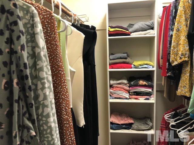 409 Guy Walker Way Durham, NC 27703 - Photo 22 of 47 a view of walk in closet with clothes and shoes