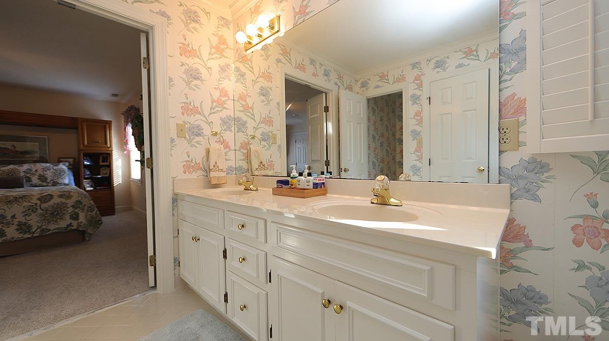 409 Guy Walker Way Durham, NC 27703 - Photo 23 of 47 a en suite bathroom with double sink and a mirror