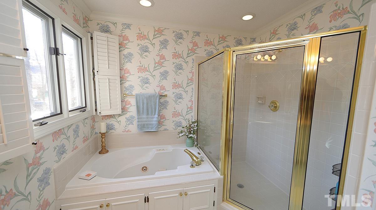 409 Guy Walker Way Durham, NC 27703 - Photo 24 of 47 a bathroom with a bathtub and a shower