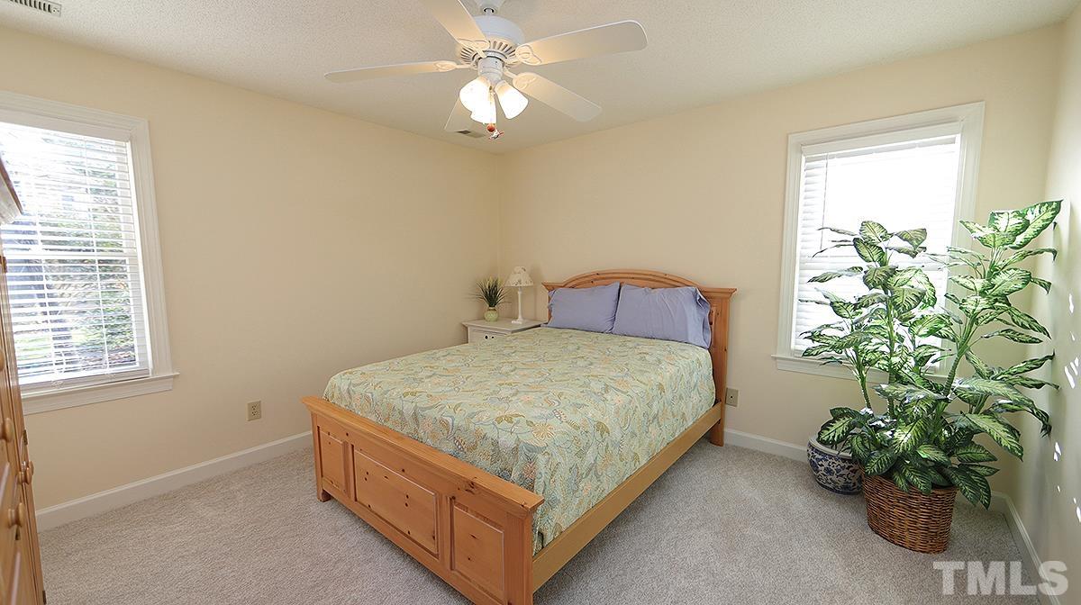 409 Guy Walker Way Durham, NC 27703 - Photo 25 of 47 a bed sitting in a bedroom next to a window