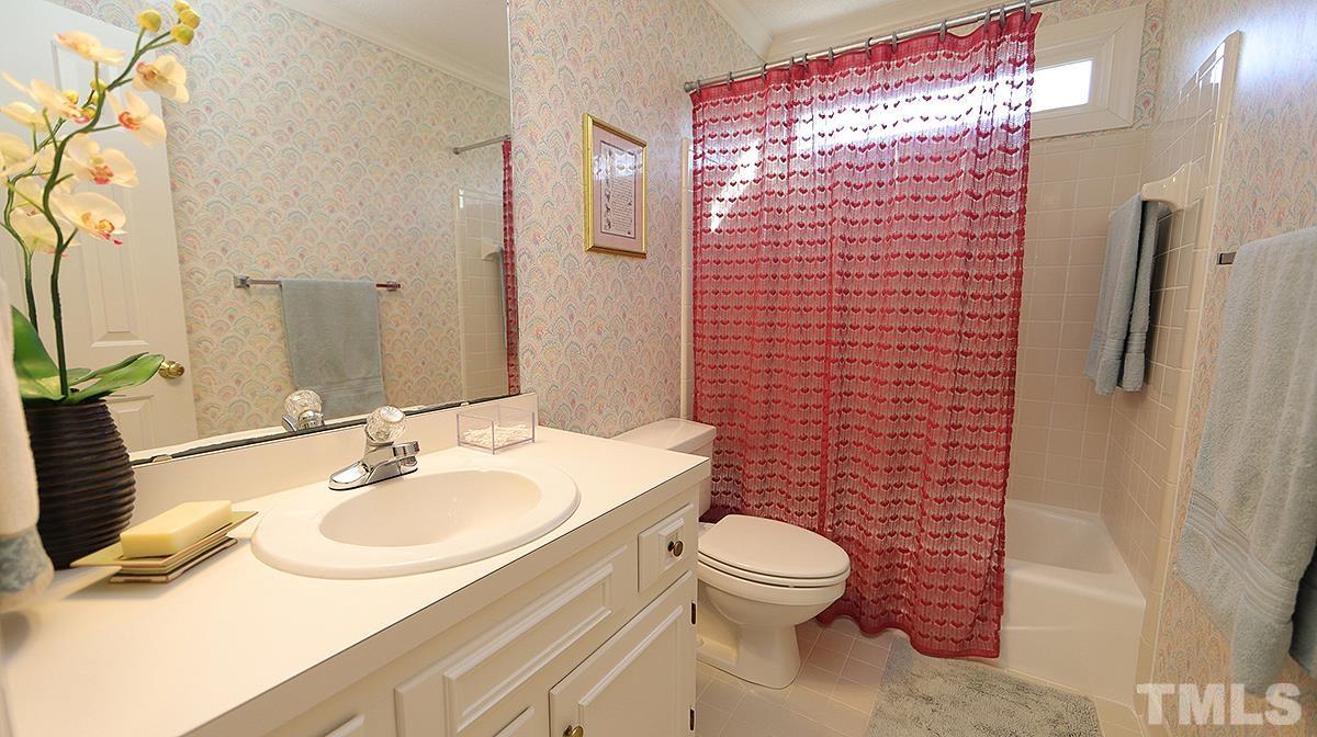 409 Guy Walker Way Durham, NC 27703 - Photo 26 of 47 a bathroom with a sink toilet and shower