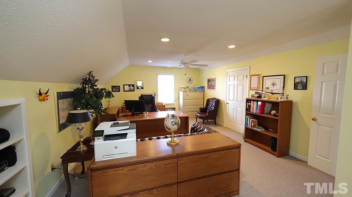 409 Guy Walker Way Durham, NC 27703 - Photo 30 of 47 a living room with furniture and a bookshelf
