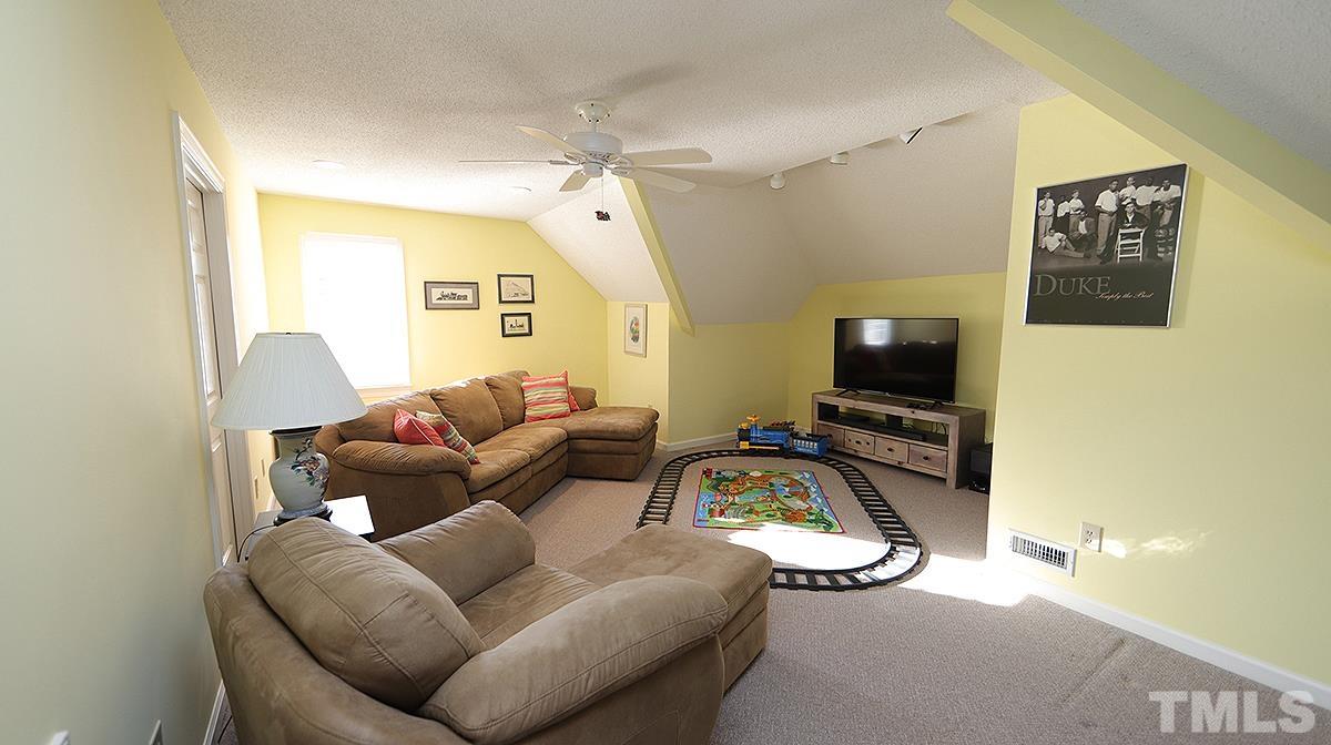 409 Guy Walker Way Durham, NC 27703 - Photo 33 of 47 a living room with furniture and a flat screen tv