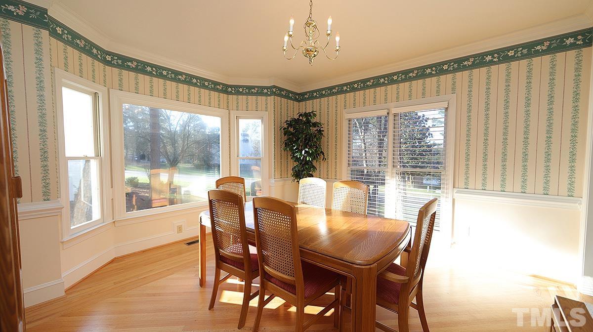 409 Guy Walker Way Durham, NC 27703 - Photo 5 of 47 a view of a dining room with furniture large windows and wooden floor