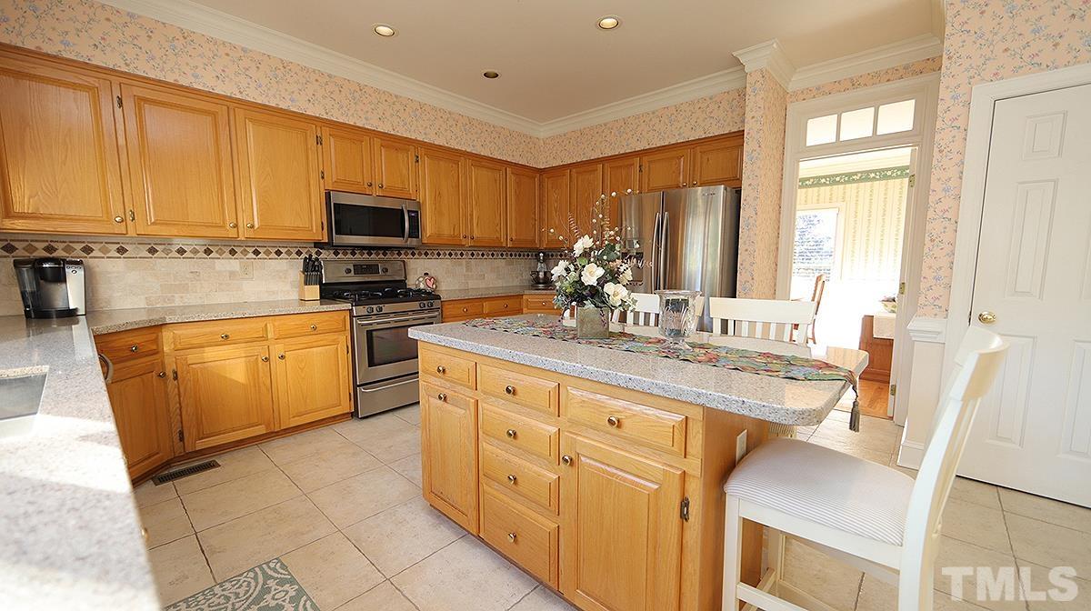 409 Guy Walker Way Durham, NC 27703 - Photo 7 of 47 a kitchen with stainless steel appliances kitchen island granite countertop a sink and cabinets
