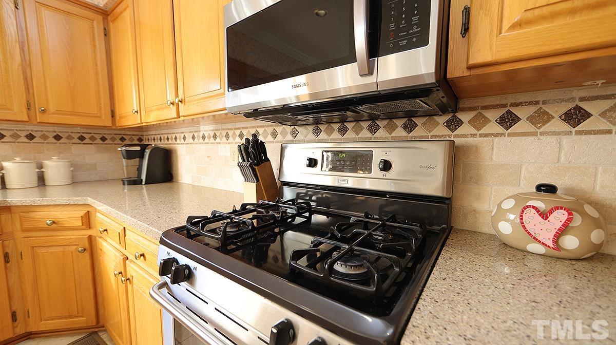 409 Guy Walker Way Durham, NC 27703 - Photo 10 of 47 a stove top oven sitting inside of a kitchen