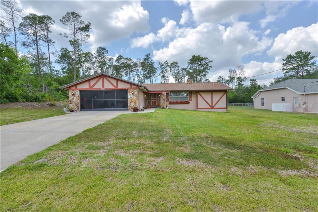 9483 Noddy Tern Road Weeki Wachee, FL 34613 - Photo 1 of 1 a view of a house with a yard and sitting area