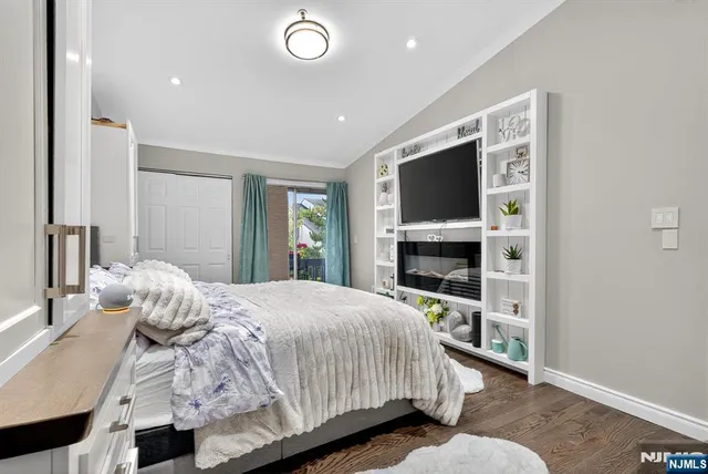 a bedroom with a bed and a flat tv screen