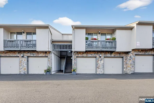 a room with granite countertop lots of wooden cabinets and a window