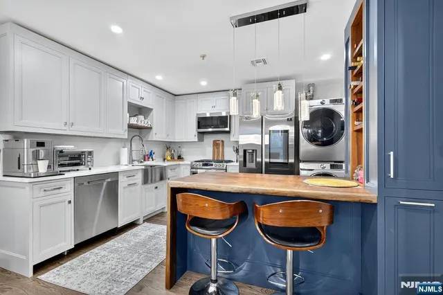 a kitchen with granite countertop a sink and cabinets