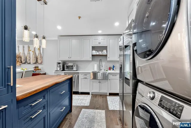 a kitchen with a sink a stove and cabinets