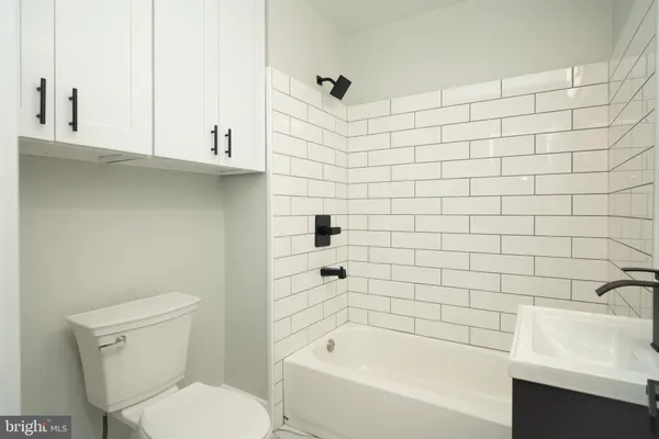 a bathroom with a bathtub and sink