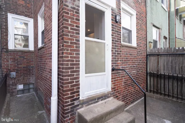 a view of door of a brick building front of house