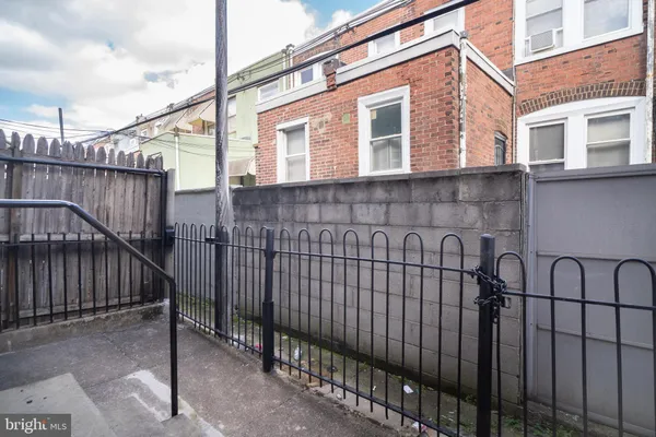 a view of a house with wooden fence