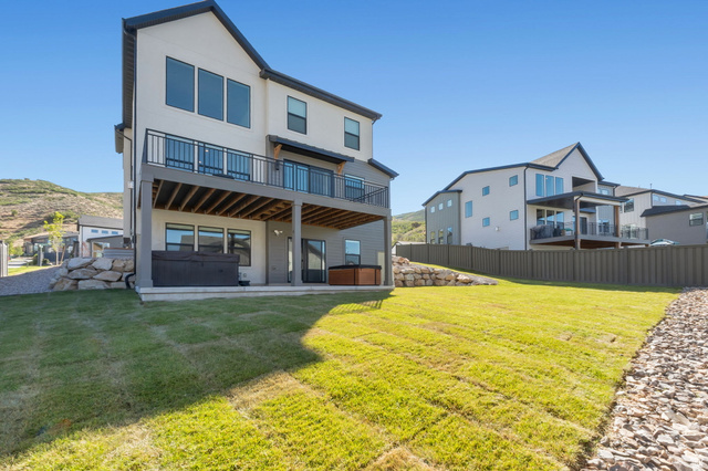 1711 West Canyon Rim Road North Lehi, UT 84048 - Photo 28 of 31 Contemporary two-story exterior with a second-story deck featuring dark railings