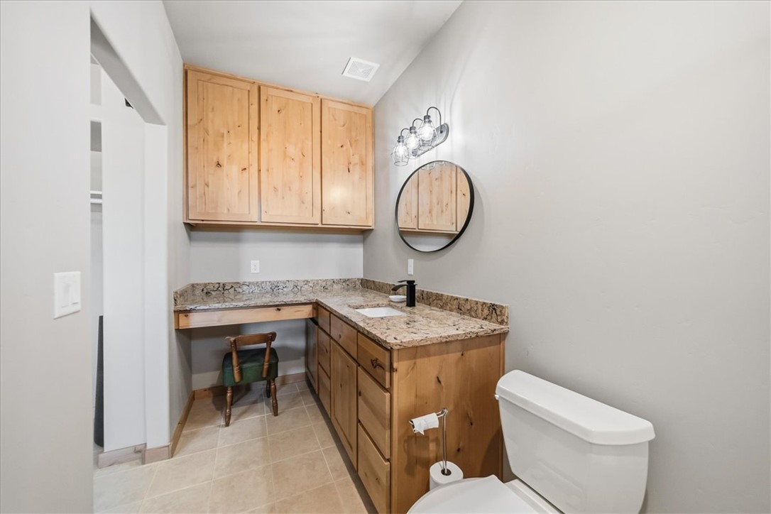 10374 East Happy Trails Road Kingman, AZ 86401 - Photo 38 of 68 a bathroom with a toilet a sink and a mirror