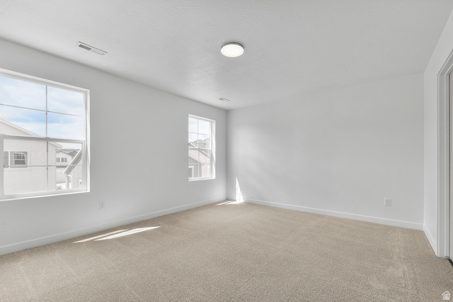 7797 West Alta Springs Way Magna, UT 84044 - Photo 15 of 21 Unfurnished room with light colored carpet and a textured ceiling