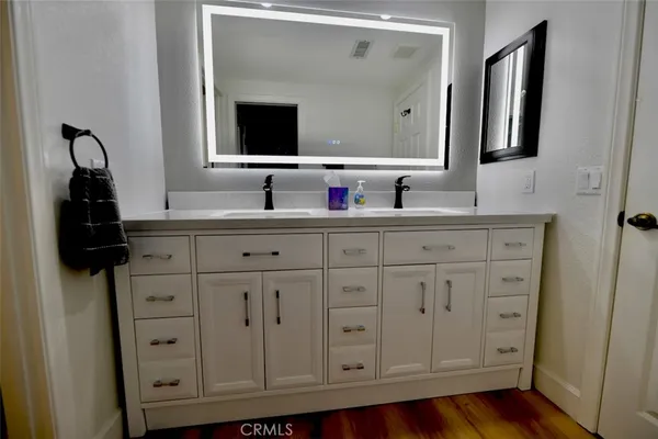 a bathroom with a sink vanity and mirror