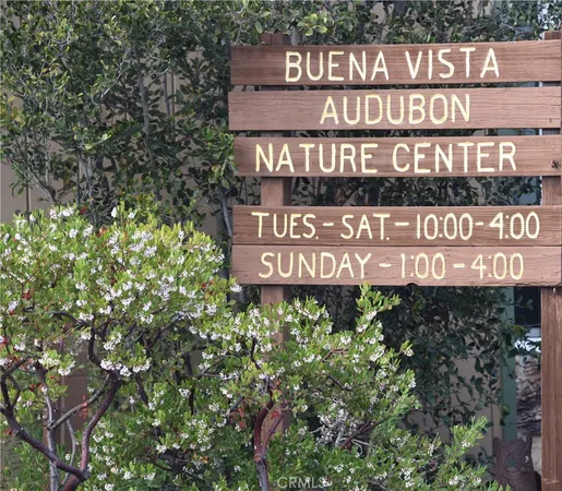 a sign broad in front of the red brick house