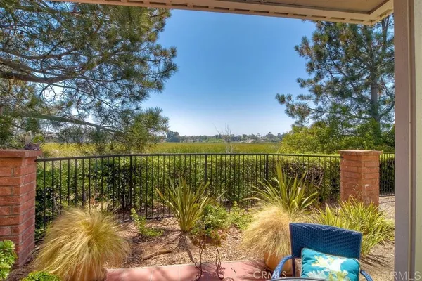 a view of a lake and a yard from a balcony
