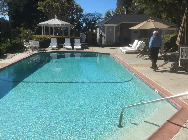 a view of a house with swimming pool and sitting area
