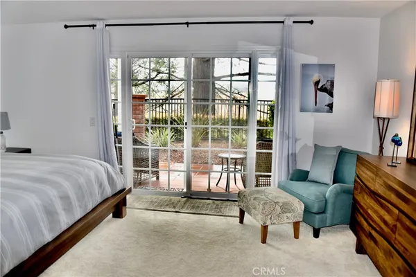 a bedroom with a bed and a mirror