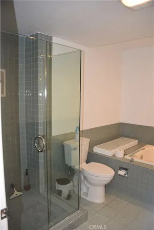 a white toilet sitting next to a bathroom sink