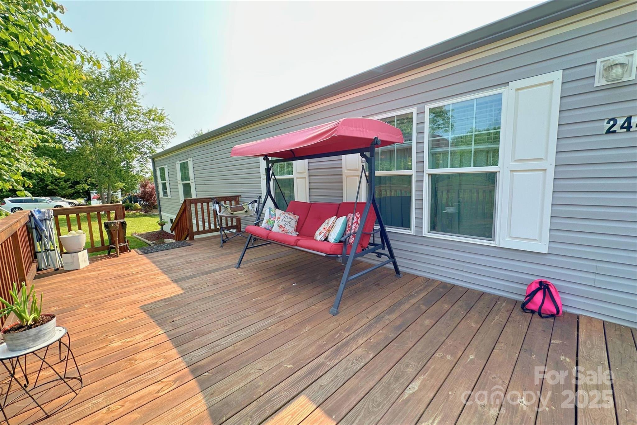 2449 Leonhart Road Cherryville, NC 28021 - Photo 14 of 21 a view of a deck with table and chairs with wooden floor and fence