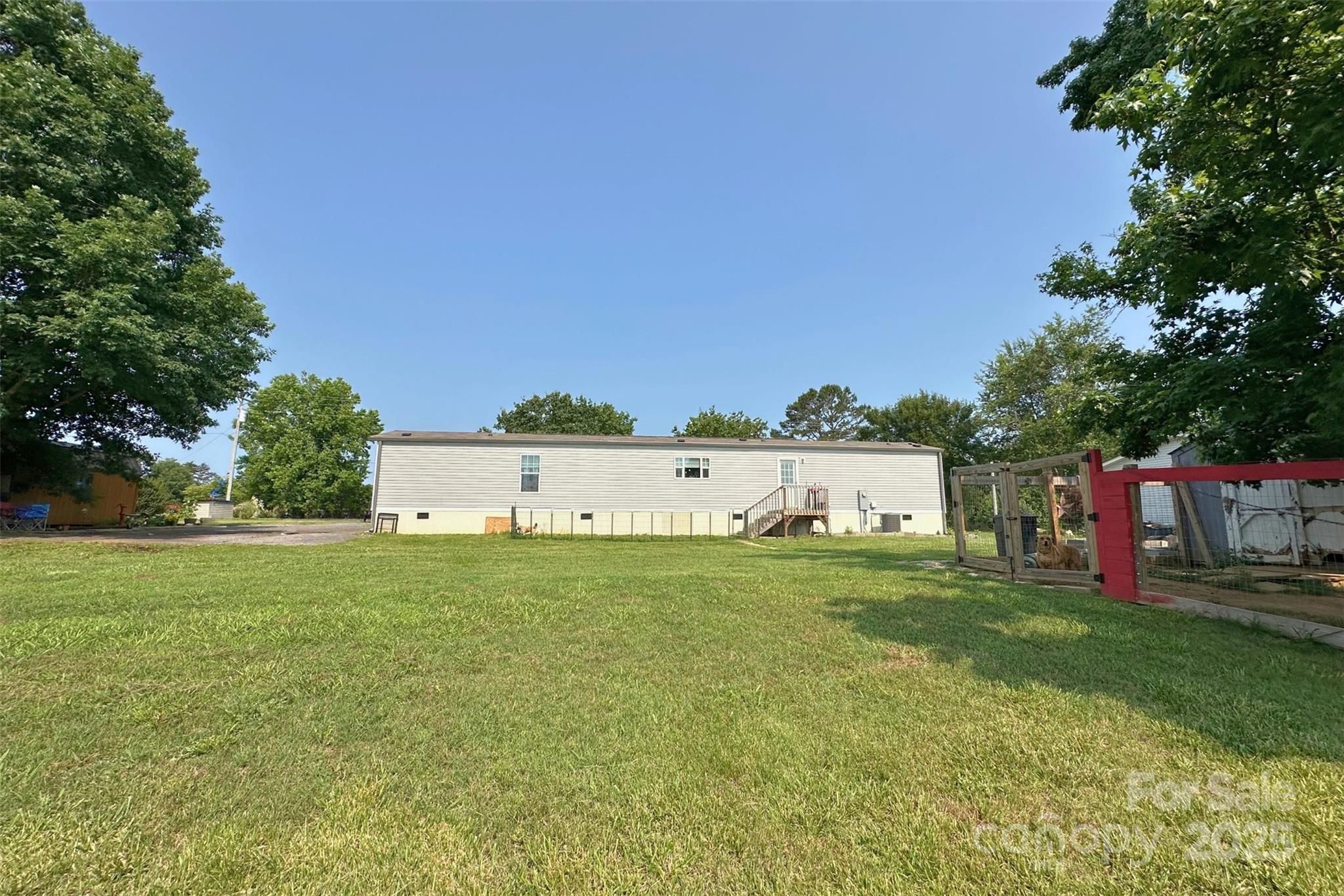 2449 Leonhart Road Cherryville, NC 28021 - Photo 16 of 21 a house with green field in front of it